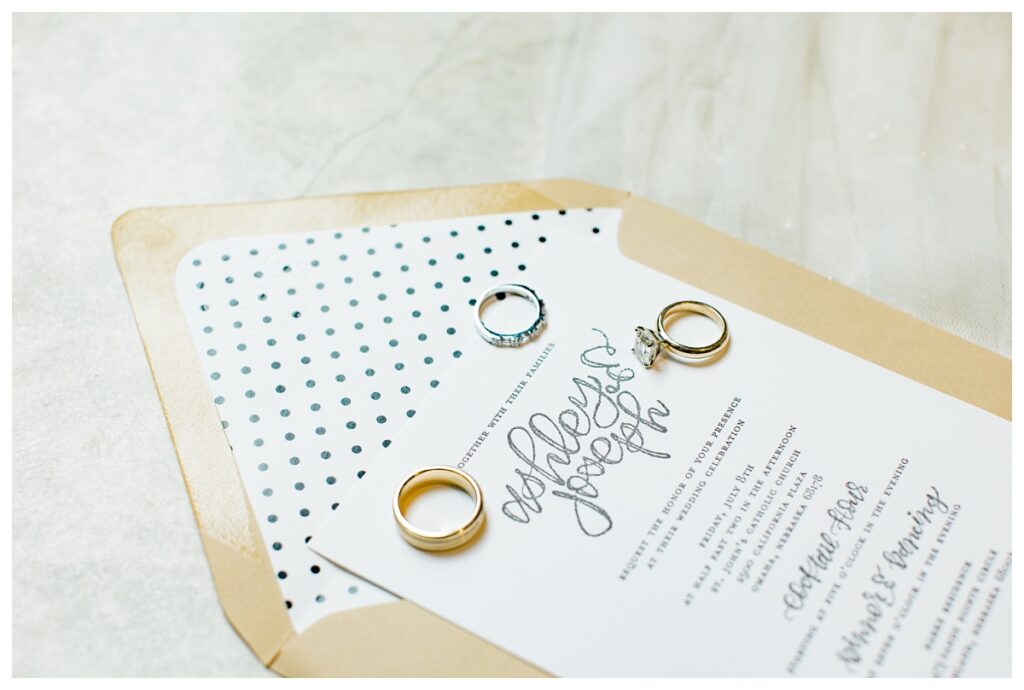 Side Angle Shot of Wedding Invitation with Rings on Marble Floor of Kimpton Cottonwood Hotel