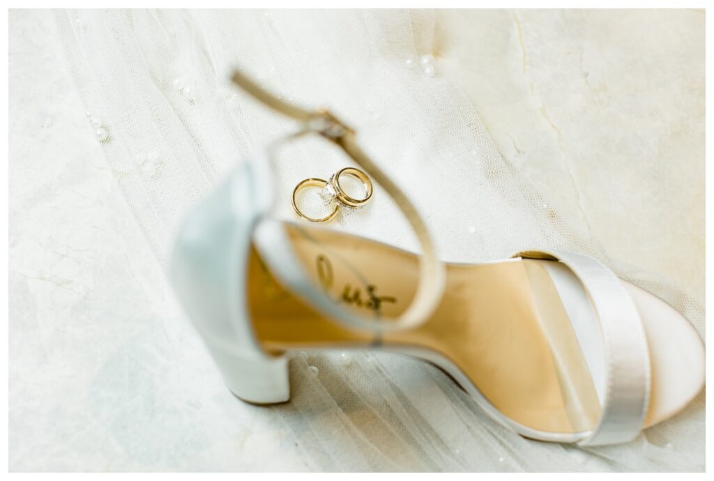 Wedding Band Ring Photo Through Heel Strap of Bride's Shoes
